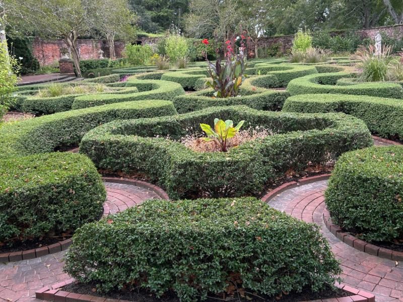 Gardens with shaped hedges and flowers and bushes